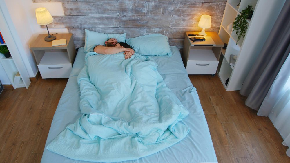 Couple in bed under
cooling weighted blanket